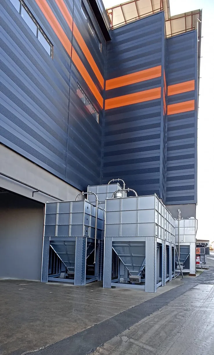 T-MAX modular silo and silobas systems positioned along the building facade